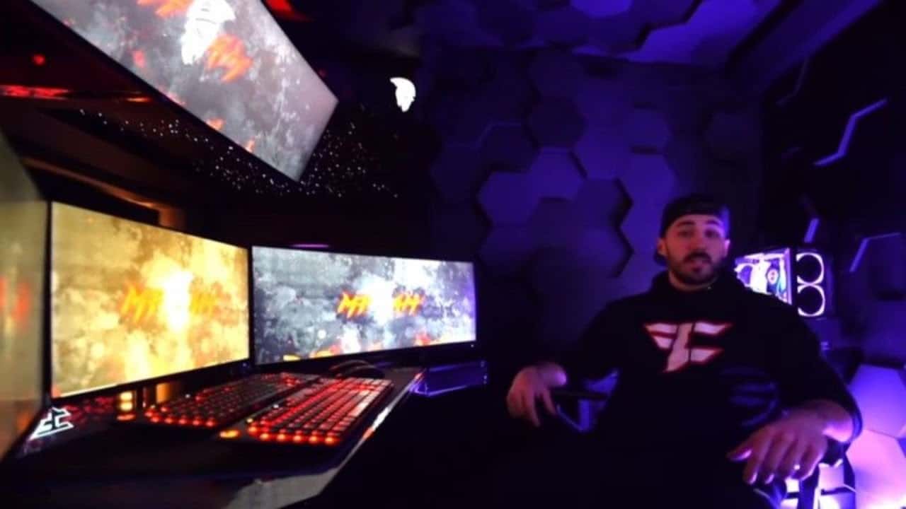 Nick “NICKMERCS” Kolcheff sits at his stream setup in his FaZe Clan hoodie, addressing the camera for his fans
